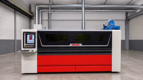 The NEONA precision fiber laser in its enclosure, control console on the left and extraction behind