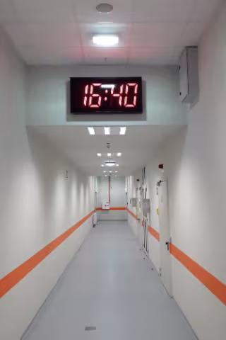 LED facade clock installed in a building corridor